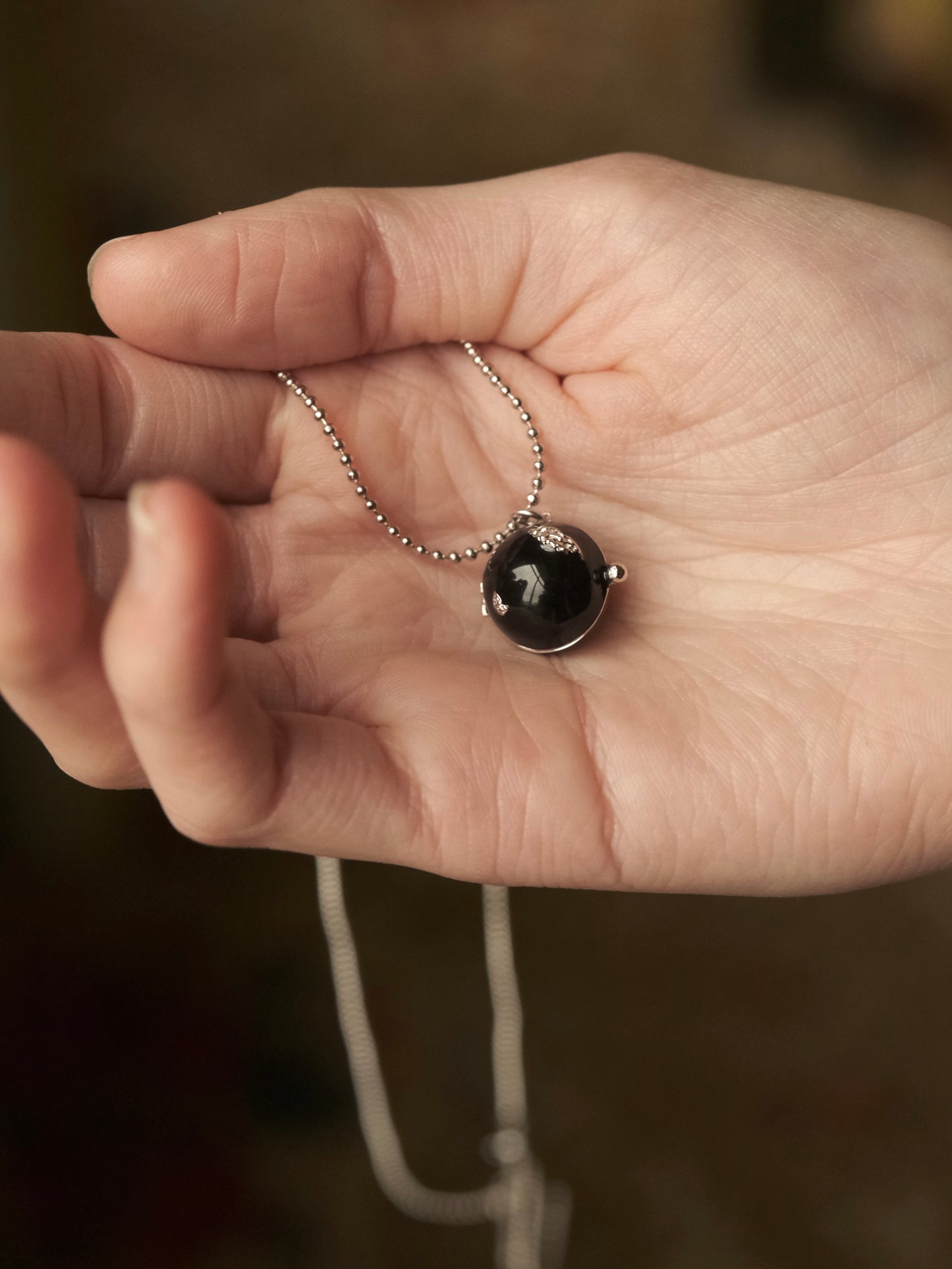 BLACK ENAMEL BALL NECKLACE WITH HIDDEN PEARLS